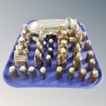 A tray of metal 32 piece chess set together with further pewter dish and jug