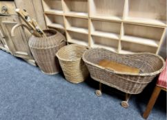 Two wicker baskets together with a wicker dolls crib on wheels, artist's box,
