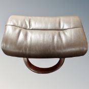 A Scandinavian glider stool in brown leather