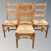 A set of four pine farmhouse rush seated ladder backed chairs