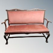 A 19th century carved hall settee in pink dralon,