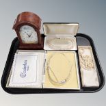 A tray of three boxed sets of costume pearls together with a contemporary mantel clock
