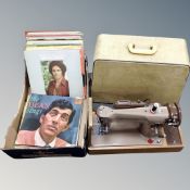A 20th century Singer electric sewing machine in case together with box of vinyl LP's,