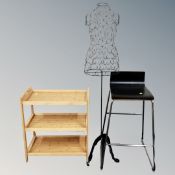 A wire metal mannequin form on stand together with a contemporary bar stool and pine three-tier