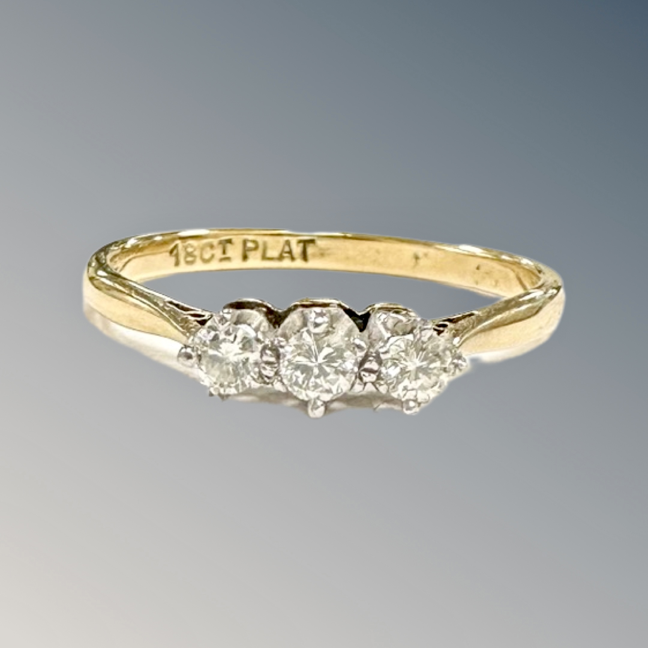 An 18ct gold and platinum three stone diamond ring, size Q CONDITION REPORT: 2.