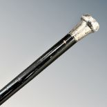 A Victorian ebonised walking cane with silver pommel, length 92cm.