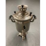 A stainless steel tea urn with tap