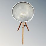 A contemporary halogen style lamp on tripod stand.