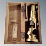A vintage brass field microscope in fitted box.