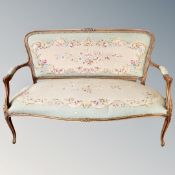 A three-piece French beech framed salon suite upholstered in tapestry fabric.