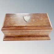 An Edwardian oak cigarette box