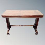 A Victorian mahogany collapsible butler's table on bun feet.