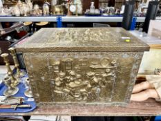 An antique brass embossed wooden coal box.