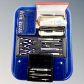 A tray of cased drawing instruments, pens,