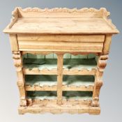 A rustic pine wine cabinet fitted a drawer