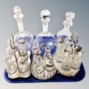 A tray of three antique cut glass cruet sets on plated stands,