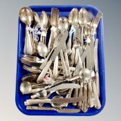 A tray containing a large quantity of Sheffield silver plate and stainless steel flatware.