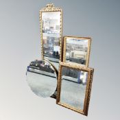 A 1930s frameless bevel edged mirror together with three further gilt framed mirrors.