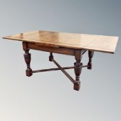 A 19th century oak pull out dining table on bulbous legs together with six leather chairs