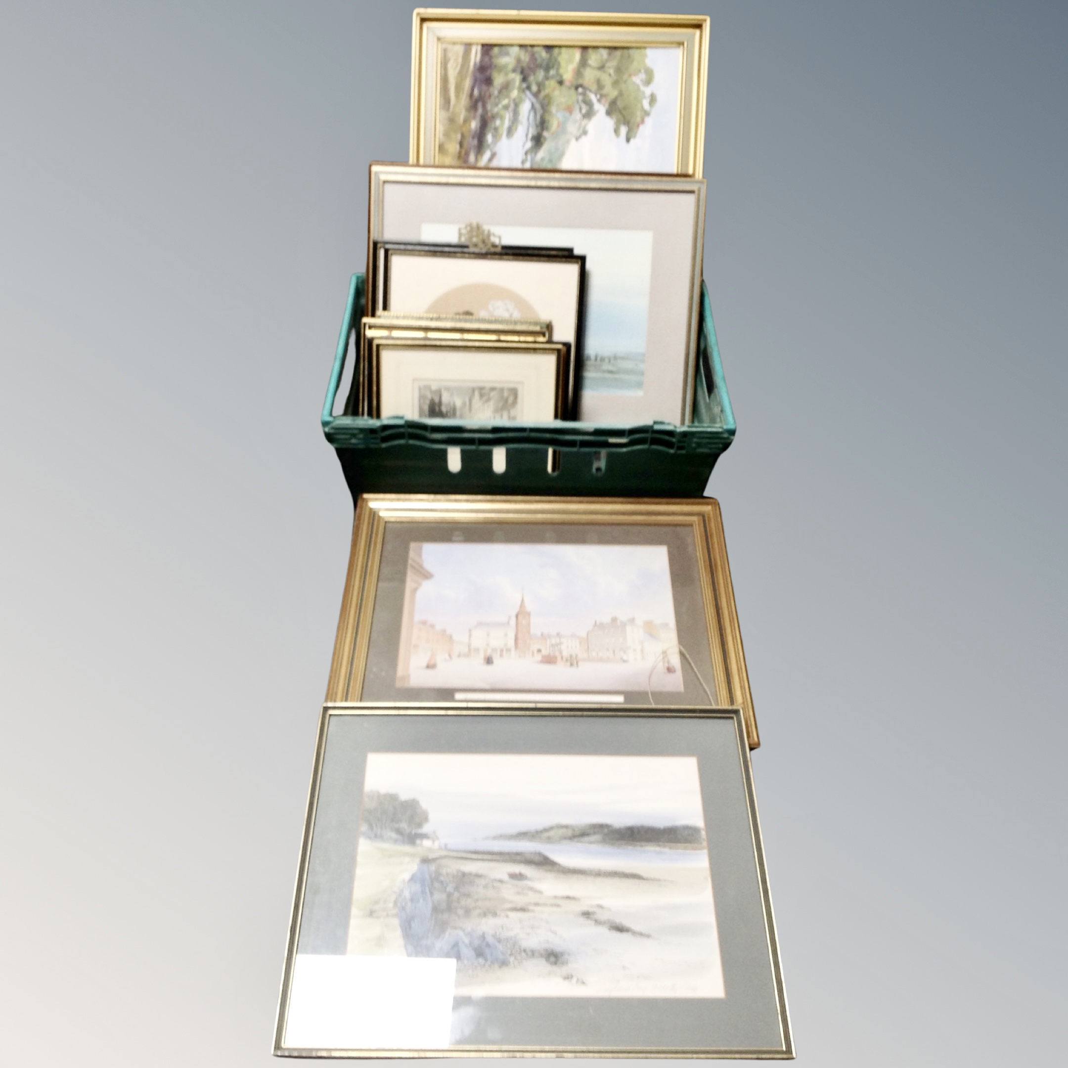 A basket containing assorted pictures, prints and etchings including a lake scene oil on board,