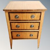 A Victorian style three drawer chest on raised legs.