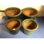 Four glazed pottery plant pots.