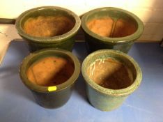 Four glazed pottery plant pots.