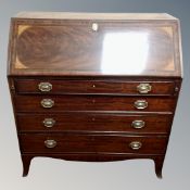 A George III inlaid mahogany fall front writing bureau fitted with four drawers.