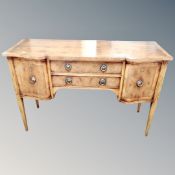 A shaped front Regency style double door sideboard fitted with two central drawers on raised legs.