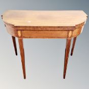 A Victorian inlaid shaped mahogany turnover top card table.