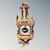 A Continental wall clock with pear drop weights.