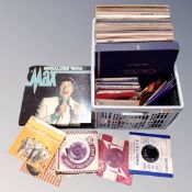 A crate containing vinyl records including LPs, box sets and 7" singles.