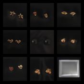 A collection of various designed boxed 9ct gold plated earrings.