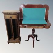 A Victorian style shaped turnover top pedestal card table together with a CD storage unit.
