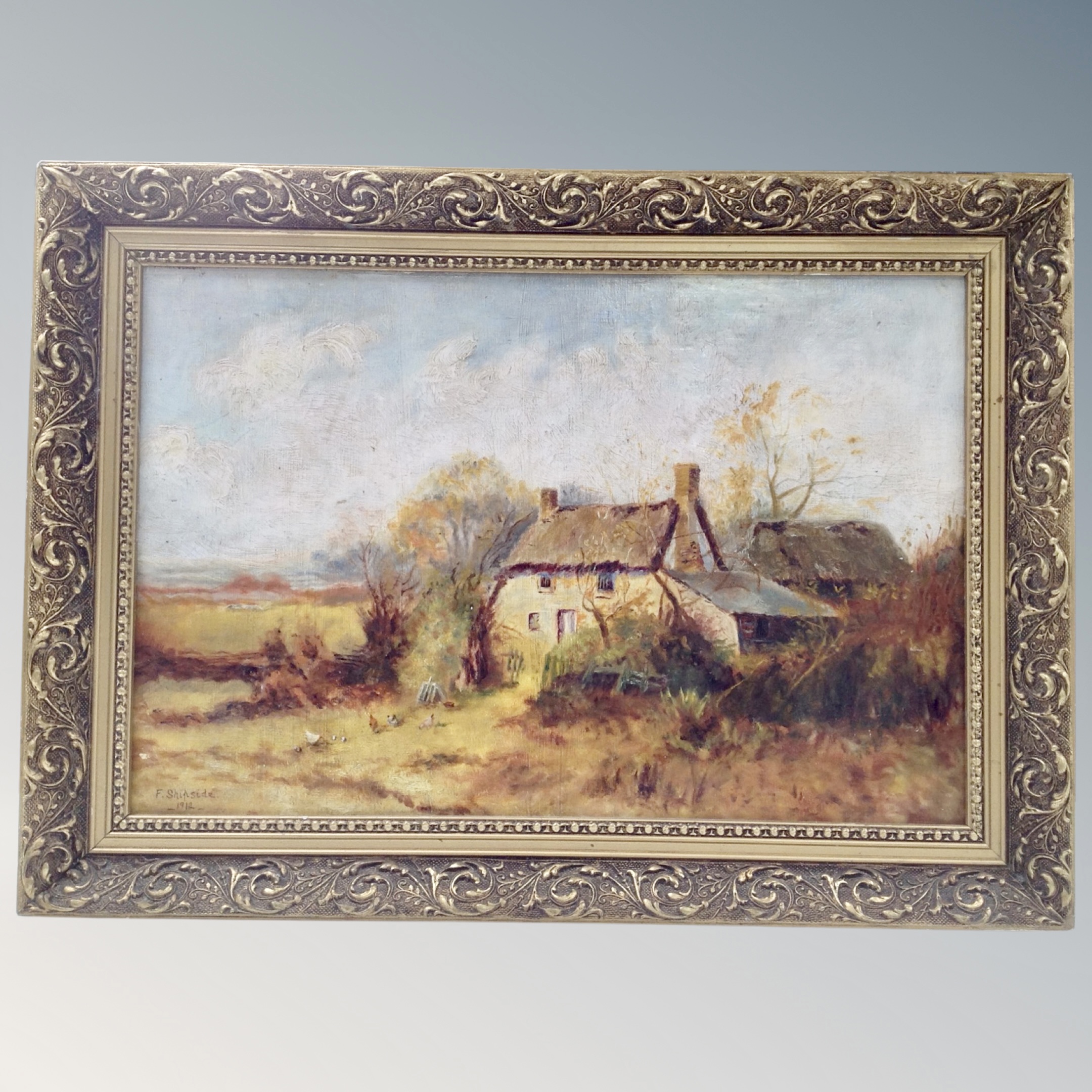 An F Shipside oil on board of a rural farmstead, dated 1912, in gilt frame.