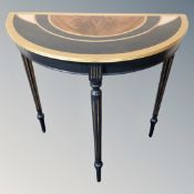 A demi lune table painted in an Art Deco style.