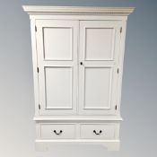 A contemporary white painted double door hanging wardrobe fitted with two drawers beneath.