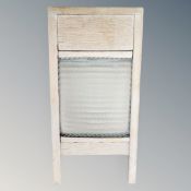A vintage pine and glass washboard.