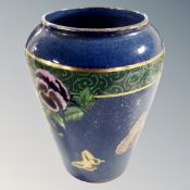 A Maling lustre vase decorated with flowers and butterflies.