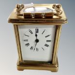 A brass cased carriage clock with key.