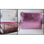 Vivienne Westwood pink shimmering clutch pouch with its original box and inside dividers. 26 cm.