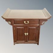 A Chinese hardwood double door altar cabinet fitted with a drawer.