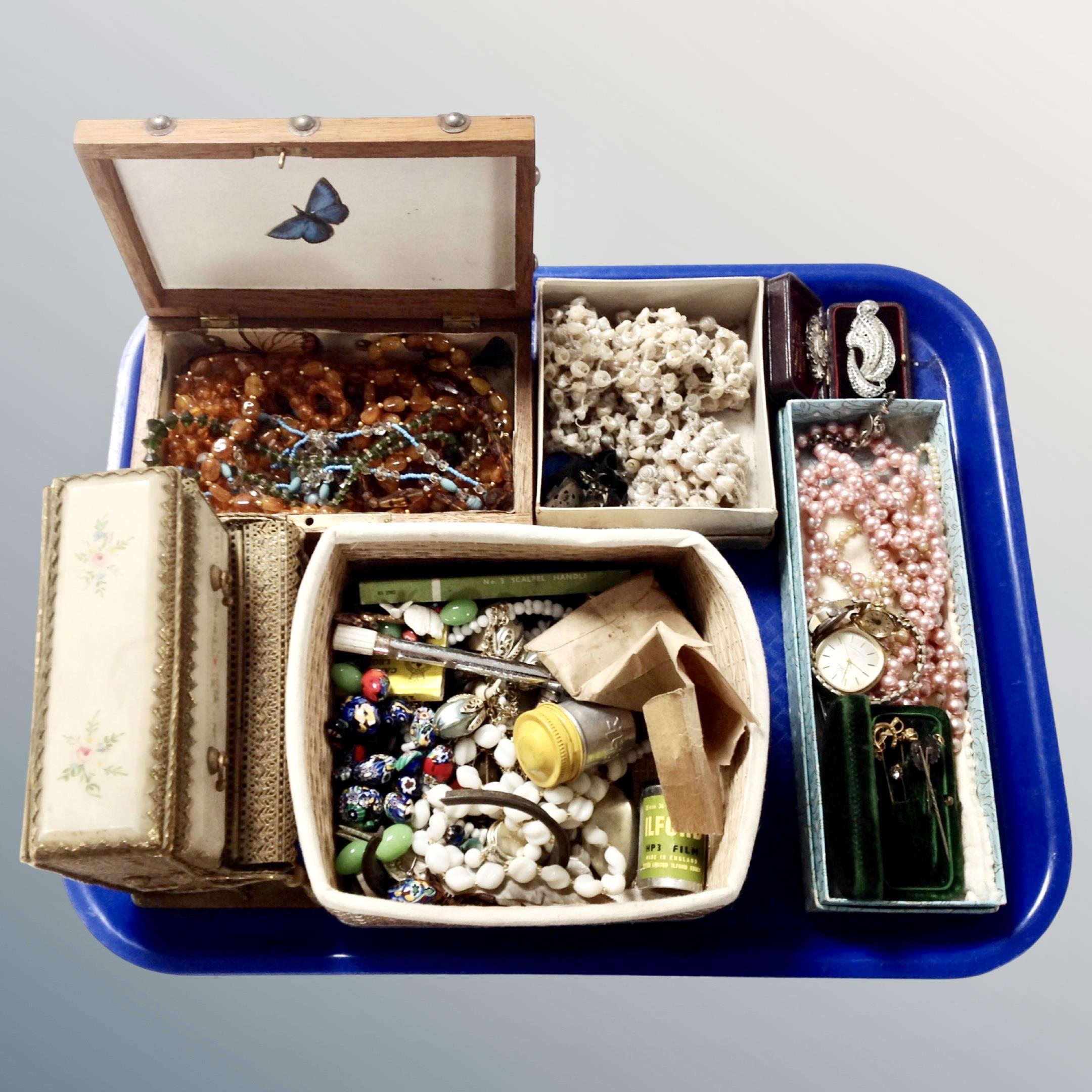 A tray containing jewellery boxes containing vintage costume jewellery including shell necklaces,