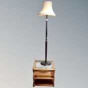 A contemporary glass top three tier lamp table together with a stained beech standard lamp with