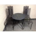 A circular metal bistro garden table together with four chairs.