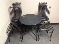 A circular metal bistro garden table together with four chairs.