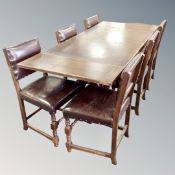 An oak pull out refectory dining table and six leather upholstered chairs
