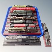 A collection of model train locomotives on plinths, prints of locomotives, etc.