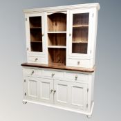 A painted pine farmhouse kitchen dresser fitted with cupboards and drawers