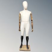 A full sized fabric wooden armed mannequin on stand